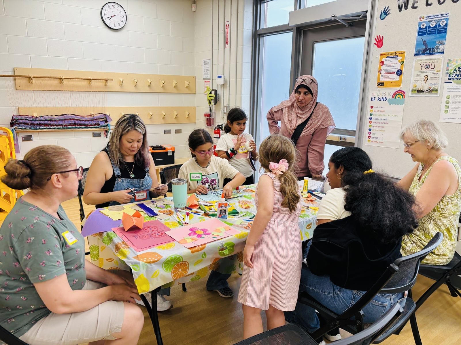 Community members creating together at the art table.
