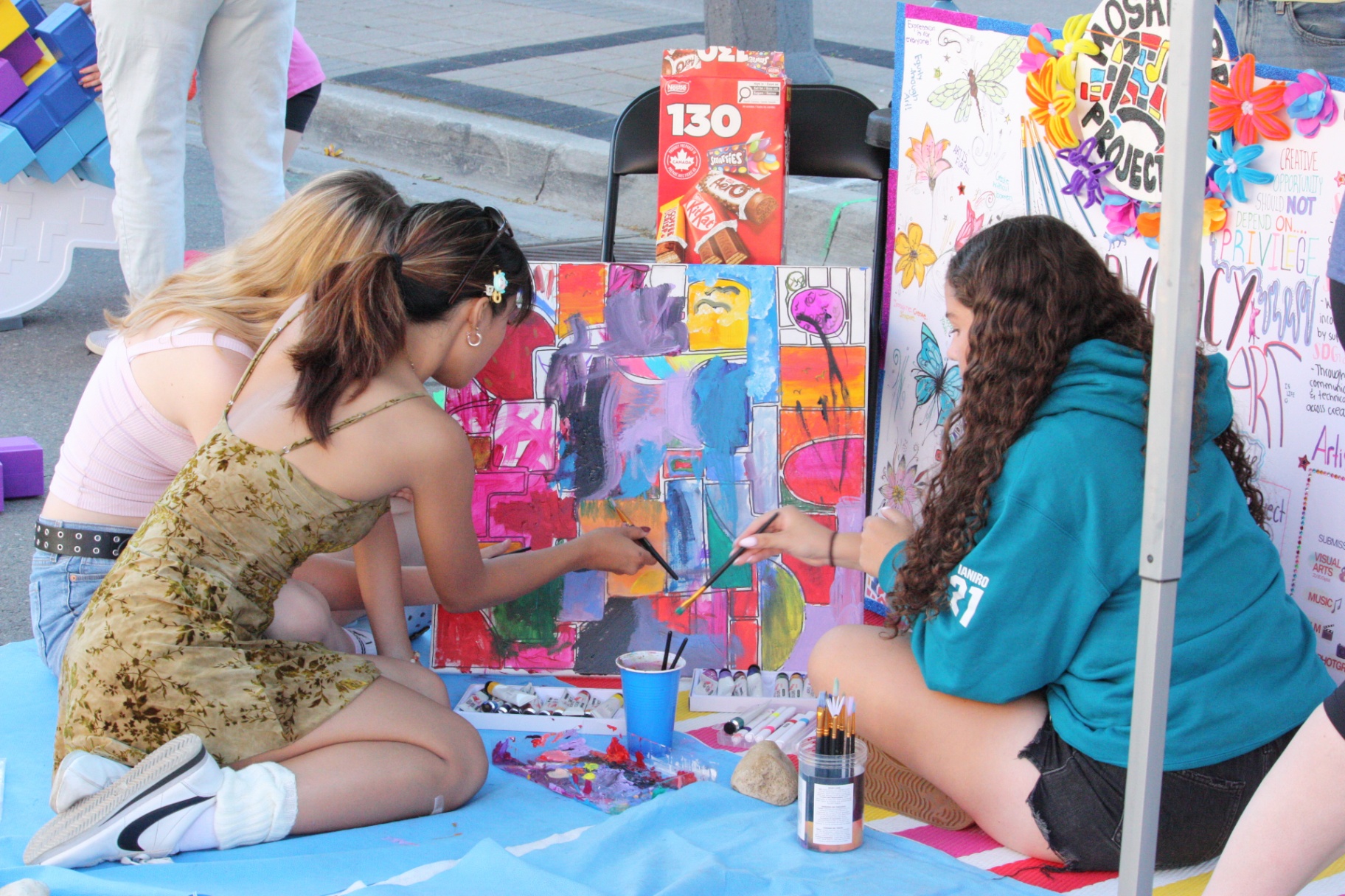 Community members adding to the mosaic canvas.