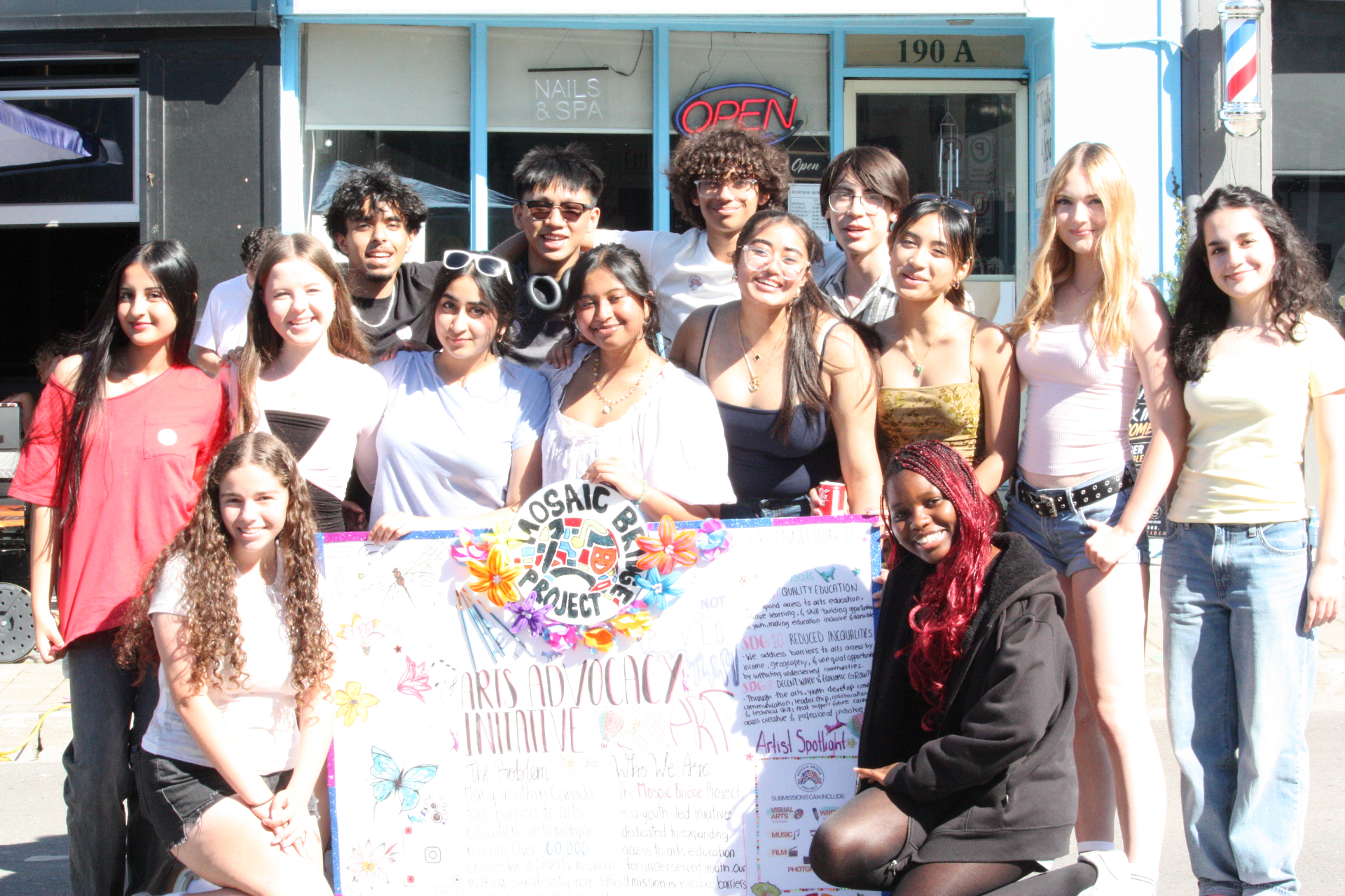 Mosaic Bridge Project youth team holding an arts advocacy poster